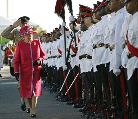 Britain's Queen Elizabeth inspects the honour guard after a Royal salute by the Bermuda Regiment at King's Square, St. George's in Bermuda November 24, 2009. The queen's three-day visit commemorates the 400th anniversary of the island's settlement.