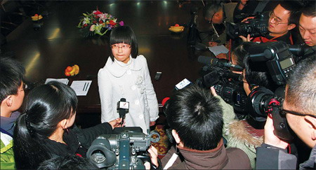 Fourteen-year-old Hong Xinge (also below) is besieged by reporters in Wuxi, Jiangsu province, on Tuesday after becoming one of the first students in China to be offered a new way into the prestigious Peking University. Hong earned a recommendation from the headmaster at Tianyi High School for an interview at the institution. She was the youngest of the 90 students who received such nominations nationwide. [Photo by Chen Liang/China Daily]