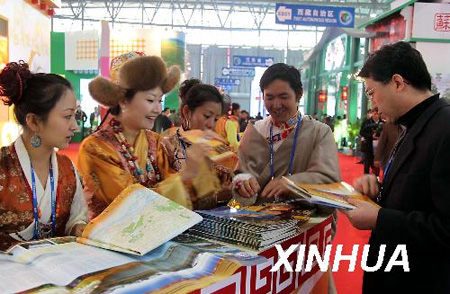 A businessman consults staff at the Tibetan booth at the China International Tourism Trade Fair held in Kunming, capital of southwest China's Tibet Autonomous Region, on Nov. 19, 2009. (Xinhua Photo) 