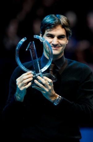 Roger Federer of Switzerland poses with the No.1 trophy at the ATP World Tour Finals tennis tournament in London, Nov. 25, 2009. He clinched the 2009 ATP World Tour year-end No.1 for the fifth time after He defeated Andy Murray of Britain at the ATP World Tour Finals Tuesday night. (Xinhua/Tang Shi)