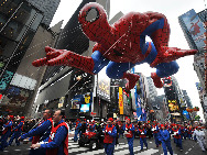  A Spiderman balloon passes through Times Square during the 83rd Macy's Thanksgiving parade in New York, the U.S., Nov. 26, 2009. [Shen Hong/Xinhua]