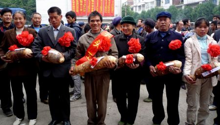 Farmers show the winners entitled &apos;taro king&apos; at the seventh taro and yam contest held in Anhe Township of Quanzhou County, southwest China&apos;s Guangxi Zhuang Autonomous Region, Nov. 25, 2009.[Wang Zichuang/Xinhua]
