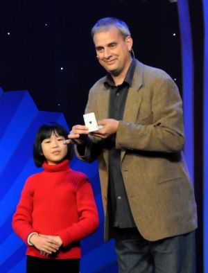 A U.S. magician performs with a Chinese girl at a magic competition held in Guannan County of east China&apos;s Jiangsu Province, Nov. 26, 2009. Forty-one magicians from 6 Asian countries and regions took part in the magic competition started on Thursday. Winners will be announced on Saturday. [Jiang Fan/Xinhua]