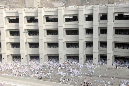 Muslim pilgrims move to take part in an exorcising ceremony to throw detritus to stone walls which symbolize the devil, during the annual hajj pilgrimage in Mecca, Saudi Arabia, Nov. 27, 2009.