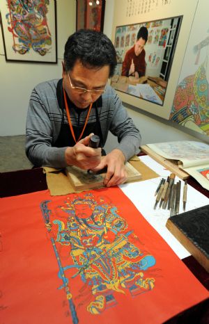 Ma Xiqin performs the making of wooden new year picture at the Chinese Intangible Cultural Heritage Show held in Taipei, Taiwan, Nov. 27, 2009.