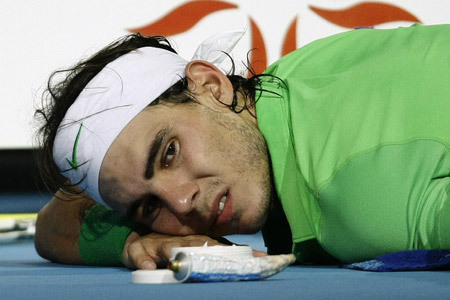 Rafael Nadal of Spain receives medical treatment during his ATP World Tour Finals tennis match at the 02 Arena against Novak Djokovic of Serbia in London November 27, 2009.