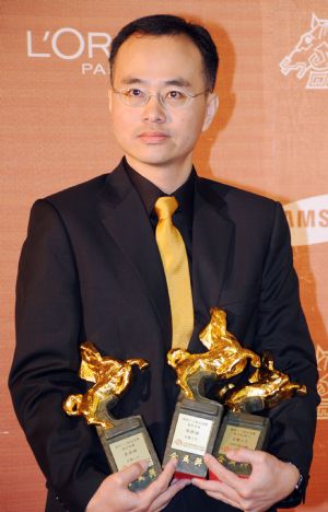 Director Cheung King-wai holds his three awards including Best Editing, Best Sound Effects and Best Documentary for 