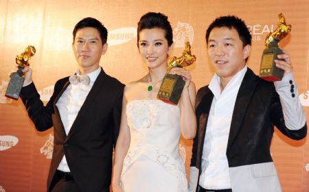 Chinese actress Li Bingbing (C), Hong Kong actor Nick Cheung (L) and Chinese actor Huang Bo hold their awards for Best Leading Actor and Actress at the 46th Golden Horse Awards in Taipei, southeast China&apos;s Taiwan Province, Nov. 28, 2009. (Xinhua/Wu Ching-teng)