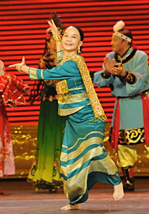 Dao Meilan, 65, a famed dancer of Chinese Dai nationality, performs during a celebration at the Great Hall of the People to celebrate the 60th anniversary of the founding of the People&apos;s Republic of China and the founding of Chinese Dancers Association in Beijing, Nov. 28, 2009. (Xinhua/Zhang Lei) 