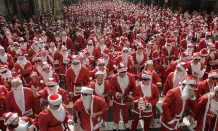 About 1,800 people dressed in Santa costumes prepare to run down the main street in central Sydney November 29, 2009. Organisers of the Variety Club Santa Fun Run, in support of a children&apos;s charity, aim to build on Sunday&apos;s event and challenge the world record for people running dressed as Santa.