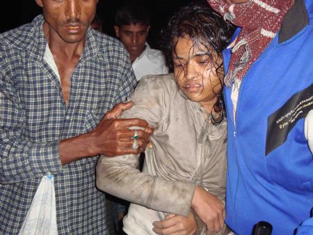 A woman is rescued from a capsized ferry in the remote coastal village Bhola, some 255 kms south of Dhaka. 