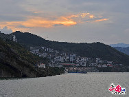 The Three Gorges Dam is a hydroelectric river dam that spans the Yangtze River in Sandouping, Yiling District,Yichang, Hubei, China. It is the world's largest electricity-generating plant of any kind. The dam site is 27 miles upstream from Yichang City proper, at Sandouping Town, 38km upstream from the Gezhouba Dam Lock, inside the third of the Three Gorges.  It has been a dream for generations.Now it has become a popular tourist site in China. [Photo by Jia Yunlong] 