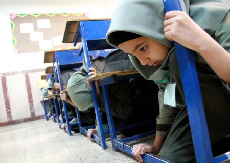 Students of a middle school attend a earthquake drill in Tehran, capital of Iran, Nov. 29, 2009. (Xinhua/Ahmad Halabisaz)