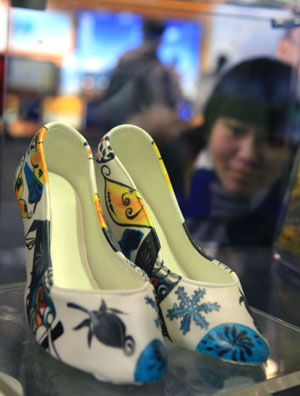 A female visitor admires a colourful high-heel shoes made of chocolate at the 4th Bejing Cultural and Creative Fair in Beijng, the capital city of China on Nov. 28, 2009. The fair, which was kicked off on Saturday, exhibited various strange and interesting cultural creations and attracted a great number of visitors.
