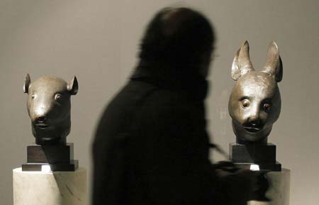 A bronze rabbit head and rat head made for the Zodiac fountain of the Emperor Qianlong's Summer Palace in China are displayed during the exhibition of the private art collection of French fashion designer Yves Saint Laurent and his partner Pierre Berge at the Grand Palais in Paris February 21, 2009. [File Photo: Xinhua]