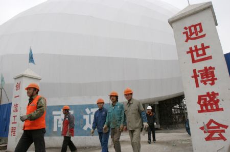 Workers walk out of the building site of China Aviation Pavilion of the 2010 Shanghai World Expo in Shanghai, east China, Nov. 29, 2009. Most of the pavilions are taking on a dashing look with the coming of the 2010 Shanghai World Expo, which will fall in May of next year. 