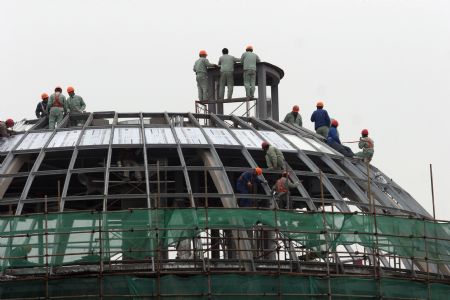 Workers proceed on a building site of the 2010 Shanghai World Expo in Shanghai, east China, Nov. 29, 2009. Most of the pavilions are taking on a dashing look with the coming of the 2010 Shanghai World Expo, which will fall in May of next year. 