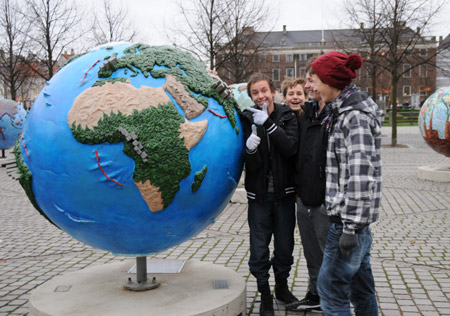 People look at globes displayed as part of an exhibition prior to the UN Climate Change Conference in Copenhagen, capital of Denmark, on Nov. 21, 2009. (Xinhua/Zhao Changchun)