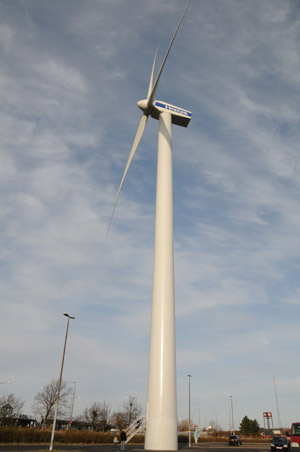 A wind turbine is seen in front of the Bella Center, where the UN Climate Change Conference will be held, in Copenhagen, capital of Denmark, Nov. 21, 2009. (Xinhua/Zhao Changchun)