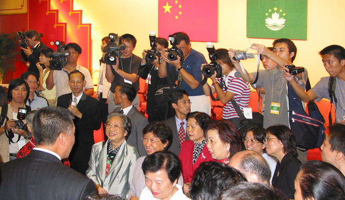 Journalists take photos during a National Day ceremony held on Oct. 1, 2003.