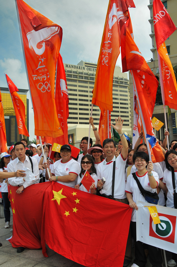 Citizens celebrate in the street as the Olympic flame arrives. Macao hosted a leg of the Beijing Olympic torch relay on May 3, 2008.