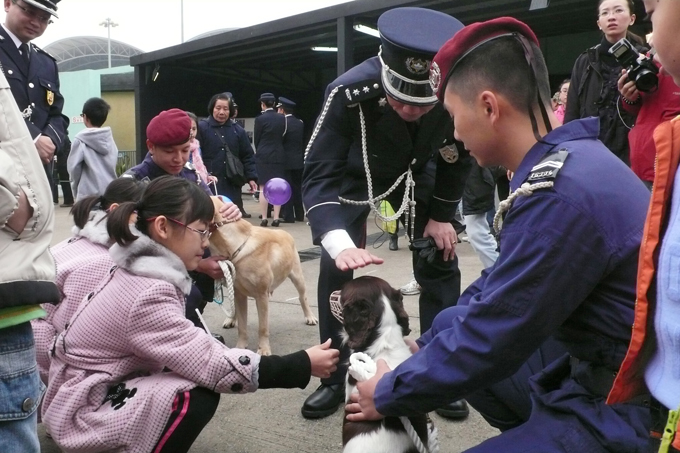 Citizens pet a police dog during the annual Macao Public Security Police ceremony.