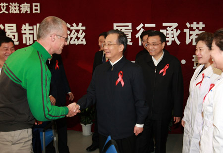 Chinese Premier Wen Jiabao (front C) shakes hands with a German HIV expert while Vice Premier Li Keqiang (3rd R) looks on at the Beijing Home of Red Ribbon in Ditan Hospital in Beijing, capital of China, Dec. 1, 2009. (Xinhua/Pang Xinglei)