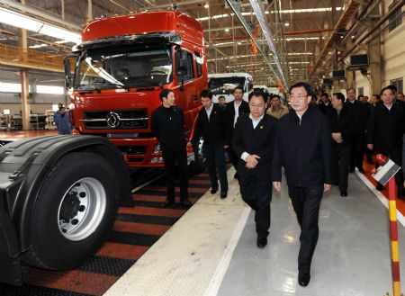 He Guoqiang (front), a member of the Standing Committee of the Communist Party of China (CPC) Central Committee Political Bureau and also secretary of the Central Commission for Discipline Inspection of CPC, inspects the Dongfeng Motor Company in Shiyan city of central China's Hubei Province on Nov. 30, 2009. 