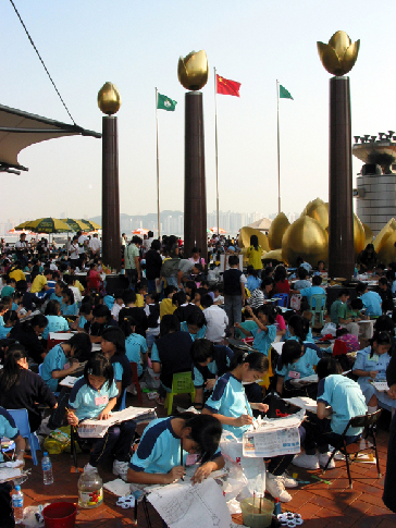 Schoolchildren paint pictures in the front of Macao Tower.