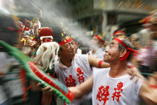 People perform drunken dances while drinking during the Feast of the Drunken Dragon.