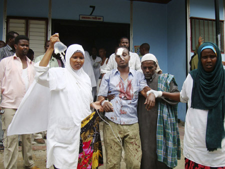 A Somali journalist wounded in an explosion at Hotel Shamo is assisted by nurses outside Madina hospital in Mogadishu, December 3, 2009. 