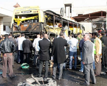 People look at the wreckage of a bus after a blast ripped through it in Sayeda Zainab, Dec. 3, 2009. Syrian Interior Minister Mohammad Sammour Thursday said the bus blast in Damascus is "not a terrorist attack," pan-Arab al-Jazeera TV reported. In press statements, Sammour said only three people have been killed when the tyre of the bus exploded. The bus was carrying Shiite Iranians who were on a tourist visit to the holy shrine of Sayeda Zainab in southern Damascus.