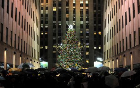 People look at the shining Christmas tree at the Rockefeller Center in New York, the United States, Dec. 2, 2009.