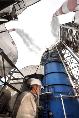 A staff member checks a desulfurizing installation at the Huaneng Fuzhou Power Plant in Fuzhou, southeast China&apos;s Fujian Province, on Dec. 1, 2009. [Jiang Kehong/Xinhua]