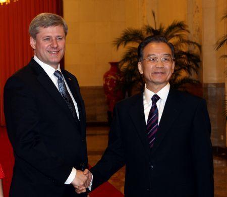 Chinese Premier Wen Jiabao (R) shakes hands with visiting Canadian Prime Minister Stephen Harper at the Great Hall of the People in Beijing, capital of China, Dec. 3, 2009. [Yao Dawei/Xinhua]