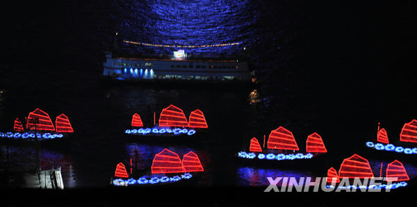 Lighting boats sail at the Victoria Harbour during the opening ceremony of the 2009 East Asian Games in Hong Kong, south China, Dec. 5, 2009. [Xinhua]