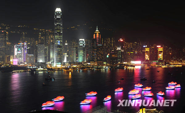 Lighting boats sail at the Victoria Harbour during the opening ceremony of the 2009 East Asian Games in Hong Kong, south China, Dec. 5, 2009. [Xinhua]