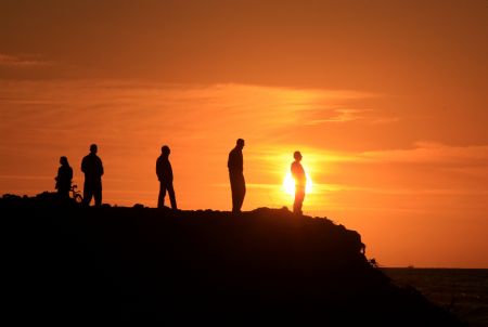 Palestinian men walk on the seashore at sunset in Gaza City, Dec.5, 2009.[Xinhua/Wissam Nassar]