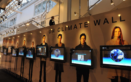 A man walks past UN Climate Wall prior to the 15th United Nations Climate Change Conference (COP15) at Bella Center in Copenhagen, capital of Demark, Dec. 6, 2009. The conference will be held from Dec. 7 to 18. [Xu Suhui/Xinhua]