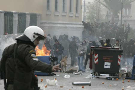 Demonstrators clash with riot police in central Athens, capital of Greece, Dec. 6, 2009. More than 10,000 policemen have deployed in Athens this weekend, as Greek authorities and citizens fear a replay of last December&apos;s riots, exactly one year after the fatal shooting of a 15-year-old student. [Marios Lolos/Xinhua]