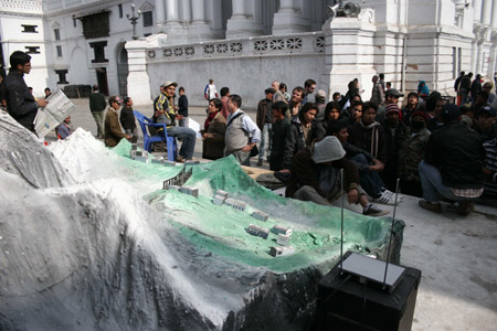 Nepalese people view the replica of the Himalayan region during an exhibition at Basantapur Durbar Square in Kathmandu, capital of Nepal, Dec. 6, 2009. The exhibition with the theme of "Stop Melting Life, Save the Himalayas" was organized to raise people
