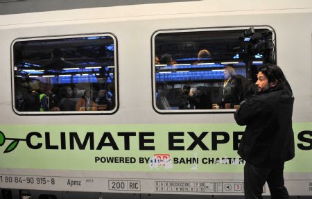 A cameraman shoots the 'Climate Express' in Brussels, capital of Belgium, Dec. 5, 2009. The 'Climate Express' arrived in Copenhagen, where the upcoming climate summit would be held, via Cologne and Hamburg after it departed from Brussels.[Xinhua] 