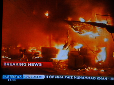 TV grab taken on Dec. 7, 2009 shows the blaze after two explosions hit the Moon Market in Lahore in east Pakistan. [Xinhua] 