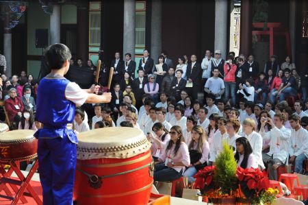 Pupils perform beating drum at the adult ceremony held in the Confucius Temple of Taipei, southeast China&apos;s Taiwan, Dec. 6, 2009. A total of 130 students took part in the Chinese traditional adult ceremony in Taipei on Sunday. [Wu Ching/Xinhua]