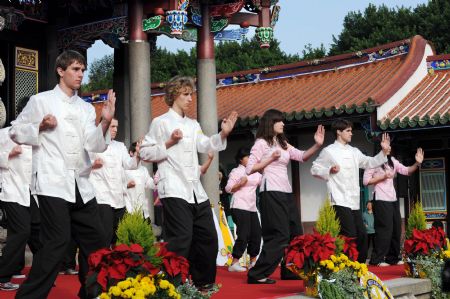 Foreign youth perform martial arts at the adult ceremony held in the Confucius Temple of Taipei, southeast China&apos;s Taiwan, Dec. 6, 2009. A total of 130 students took part in the Chinese traditional adult ceremony in Taipei on Sunday. [Wu Ching/Xinhua]