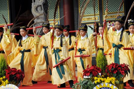 Pupils perform ancient dance at the adult ceremony held in the Confucius Temple of Taipei, southeast China&apos;s Taiwan, Dec. 6, 2009. A total of 130 students took part in the Chinese traditional adult ceremony in Taipei on Sunday. [Wu Ching/Xinhua]