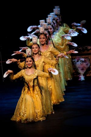 China&apos;s Xinjiang troupe performers pose during a singing and dancing performance in Brisbane, Australia, on Dec. 7, 2009. Brisbane serves as the second stop of China&apos;s Xinjiang foreign cultural exchange delegation during its visit in Australia. [Chen Mingwei/Xinhua]