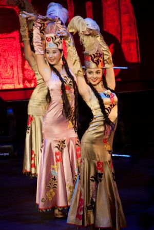 China&apos;s Xinjiang troupe performers pose during a singing and dancing performance in Brisbane, Australia, on Dec. 7, 2009. Brisbane serves as the second stop of China&apos;s Xinjiang foreign cultural exchange delegation during its visit in Australia. [Chen Mingwei/Xinhua]