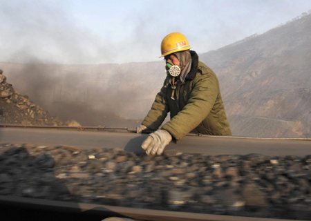 A miner works at the Haizhou open-cast coal mine in Fuxin, Liaoning province November 22, 2009. Fuxin, in China's northeast Liaoning Province, which relied mainly on mining in the past, is the first pilot city identified by the State Council to transform its economy, Xinhua News Agency reported.