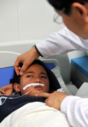 A student injured during the stampede receives treatments in a Hospital in Xiangtan City, central China&apos;s Hunan Province, Dec. 8, 2009. [Xinhua]